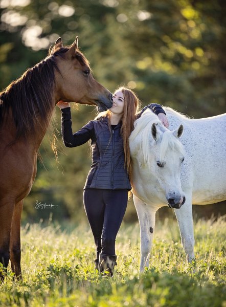 Portrait of woamn with two horses