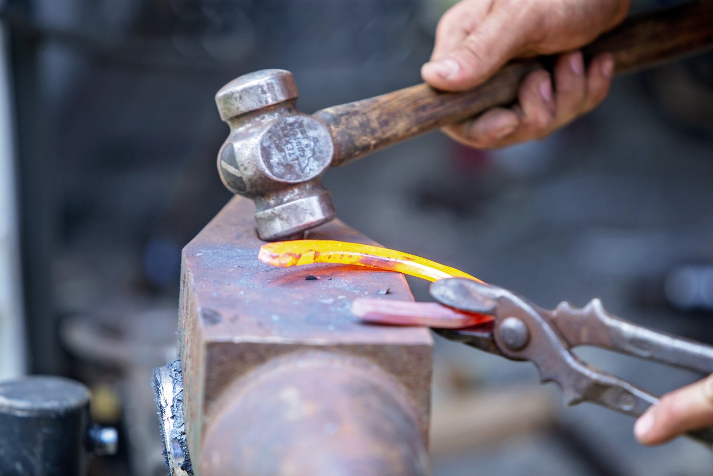 image of a blacksmith shaping a hot shoe
